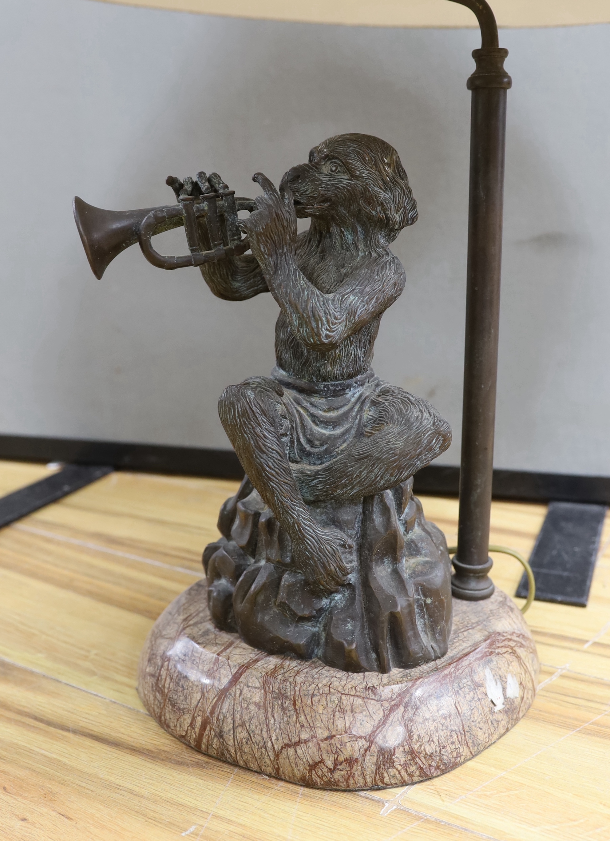 A bronzed metal monkey trumpet playing table lamp, approx. 70cm high including shade
